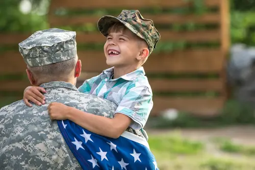 Military father holding his smiling son FSGLI