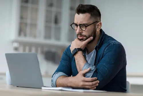Man contemplating life insurance needs at his desk
